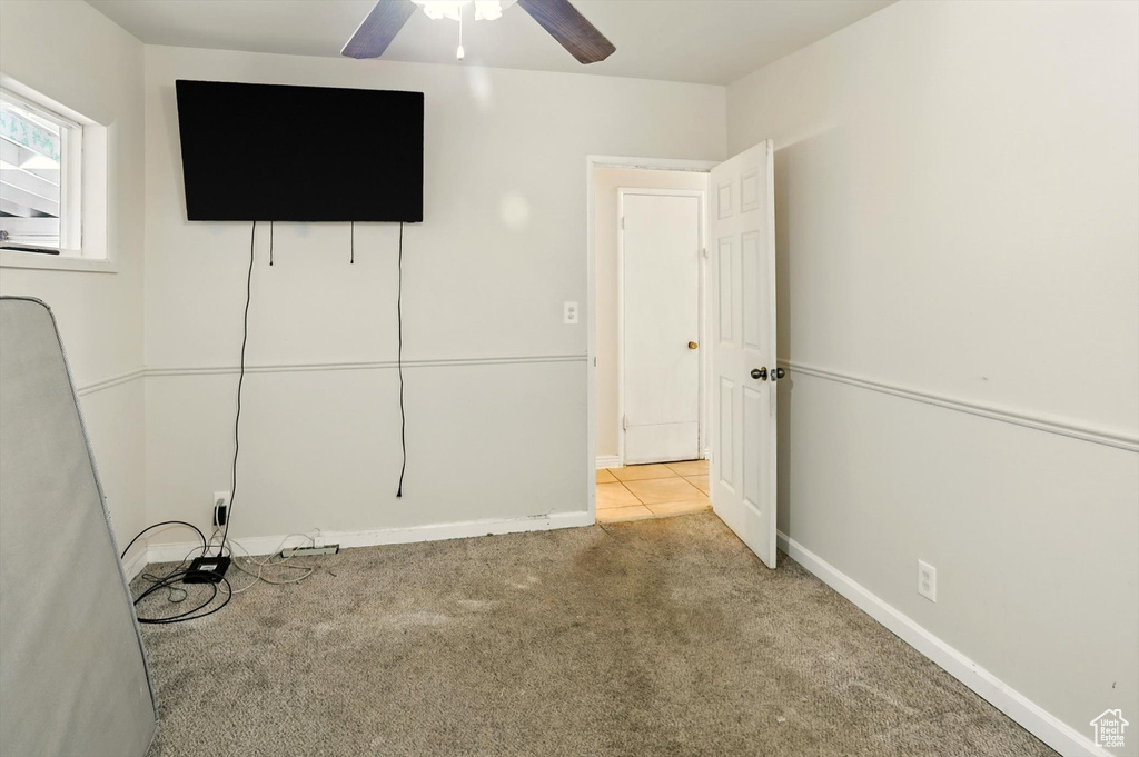 Unfurnished bedroom featuring carpet floors and ceiling fan