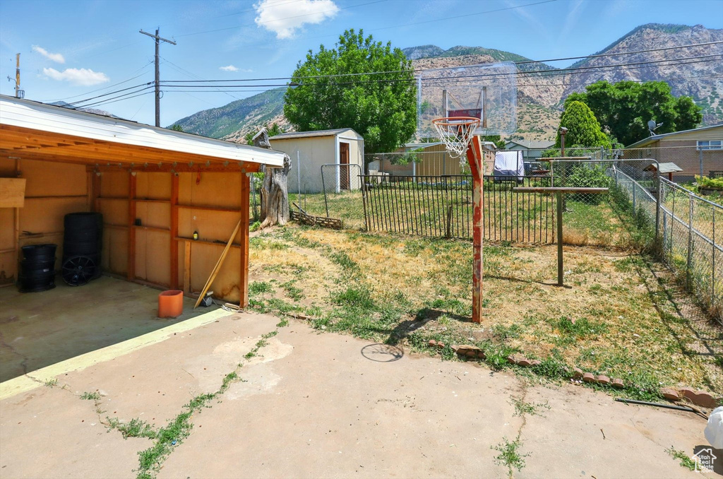 View of yard featuring a mountain view and a shed