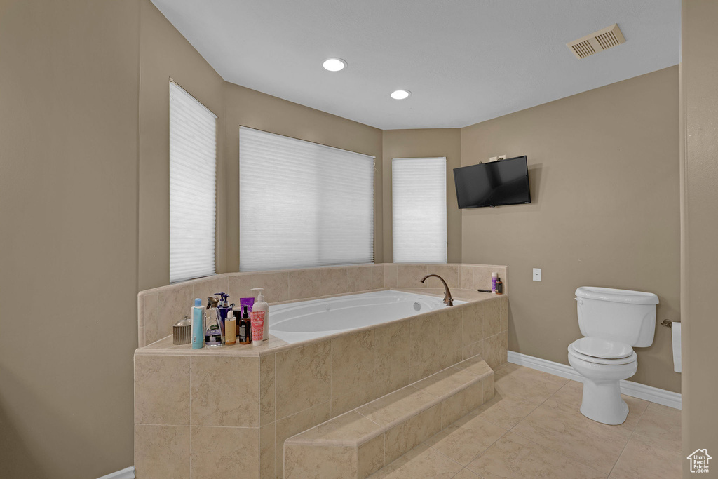 Bathroom with a garden tub and recessed lighting