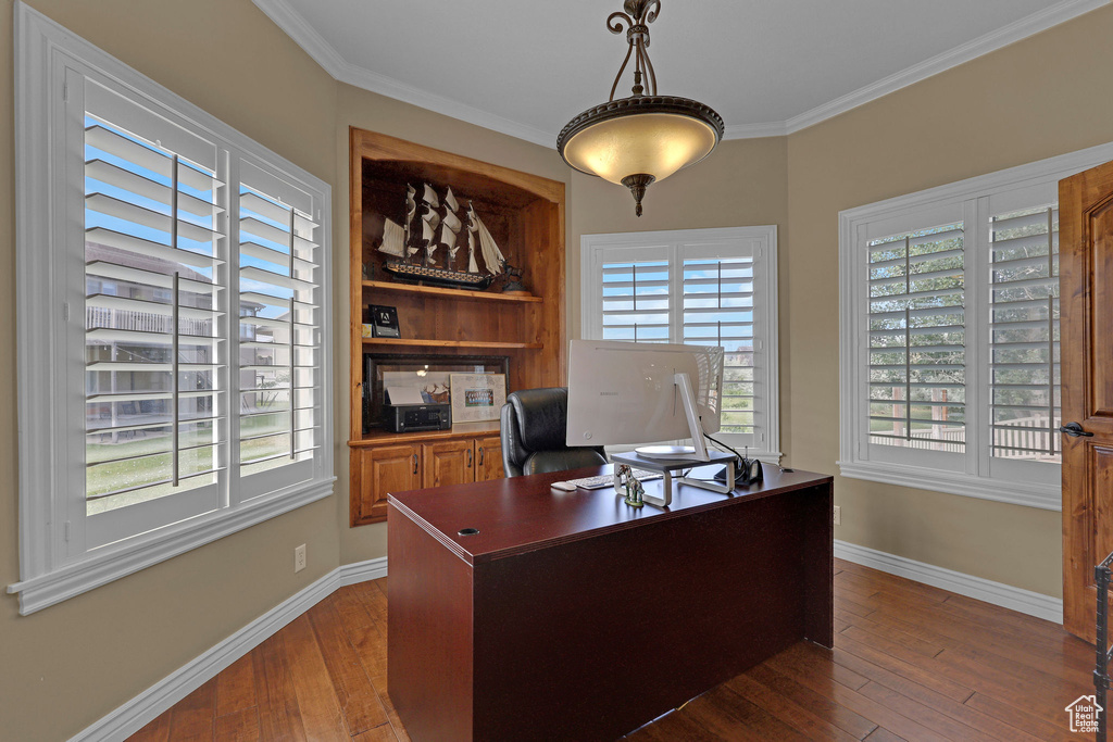 Office area featuring dark wood-type flooring and ornamental molding