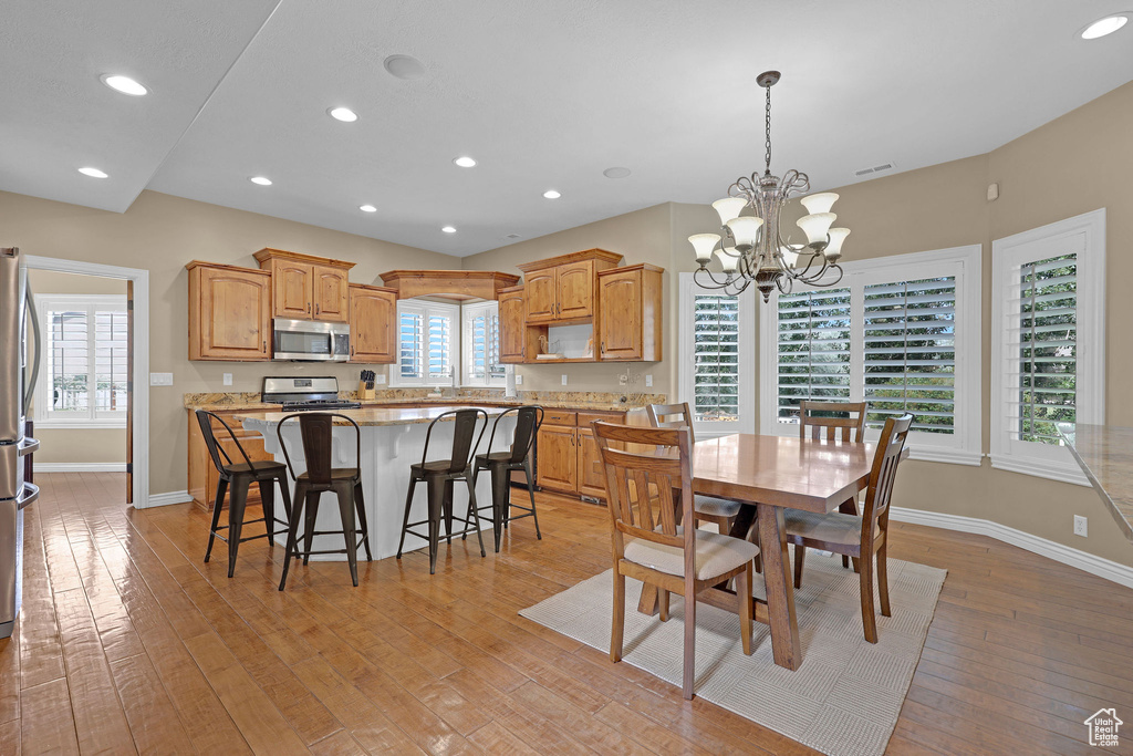 Dining area featuring light wood-style flooring, a chandelier, and recessed lighting