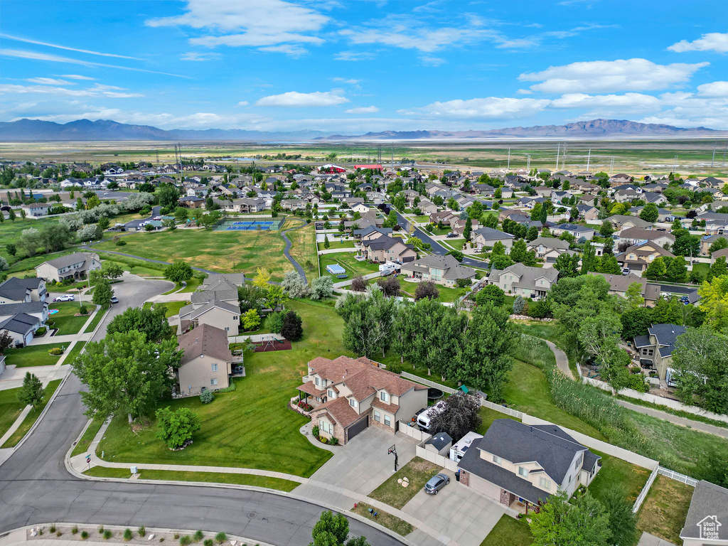 Aerial view of property's location featuring nearby suburban area and a mountain backdrop