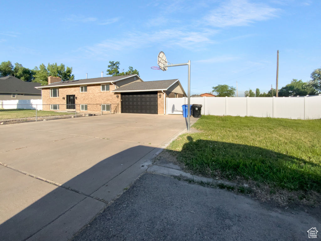 View of front of home featuring brick siding and a garage