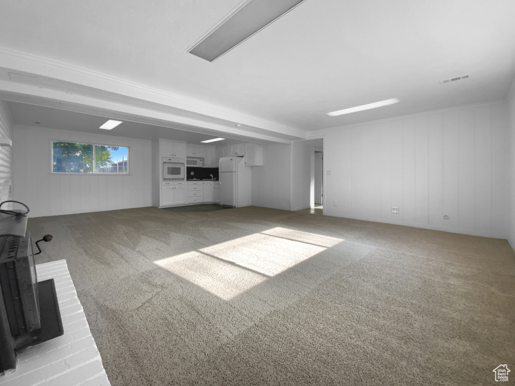 Unfurnished living room with carpet floors
