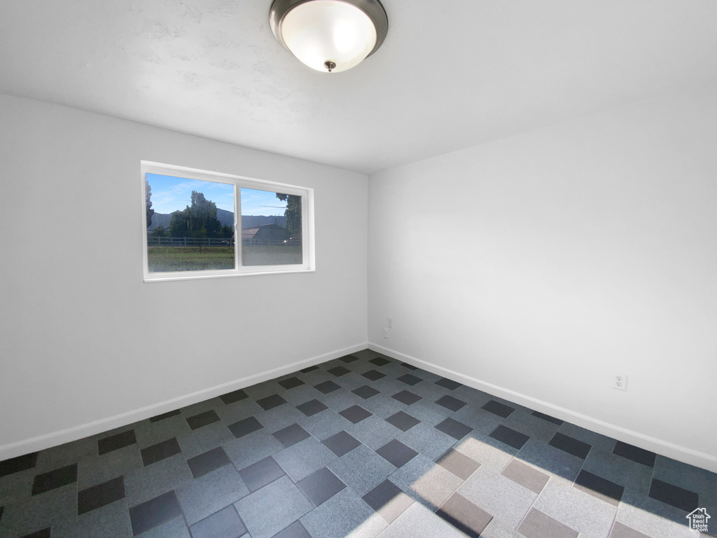 Unfurnished room featuring baseboards
