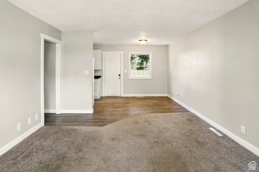 Entrance foyer with carpet and wood finished floors