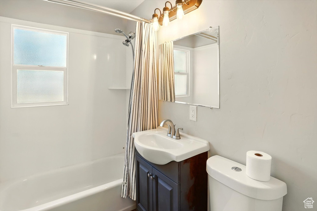 Full bath featuring vanity and shower / bath combo