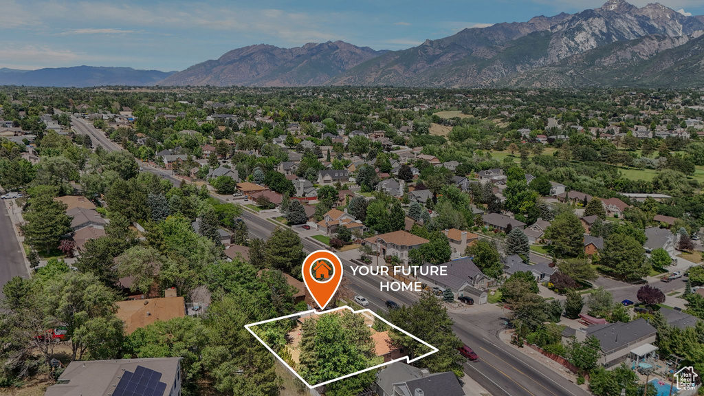 Aerial view of residential area featuring mountains and property boundaries highlighted