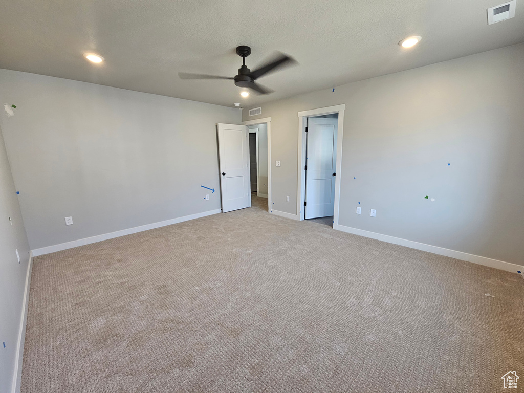 Unfurnished bedroom with light carpet, recessed lighting, and a ceiling fan
