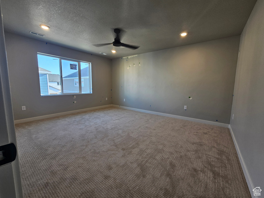 Unfurnished room featuring ceiling fan, carpet flooring, a textured ceiling, and recessed lighting