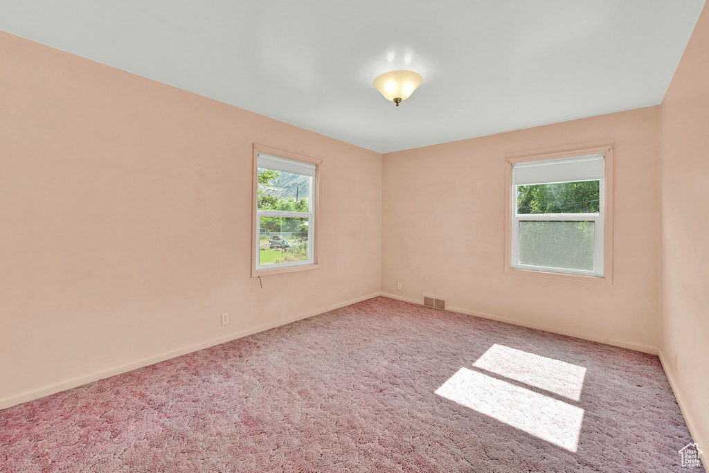 Carpeted empty room with baseboards