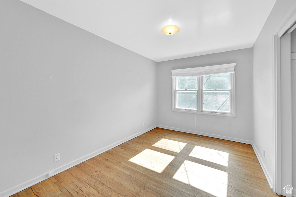 Spare room featuring baseboards and light wood-style floors