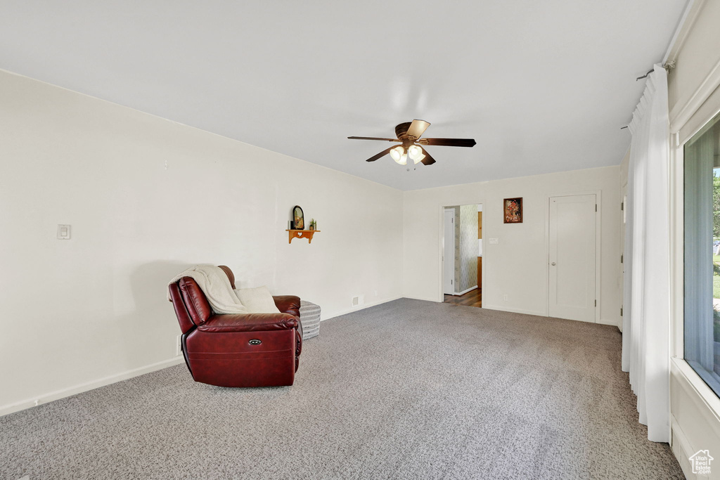 Unfurnished room featuring carpet flooring and a ceiling fan