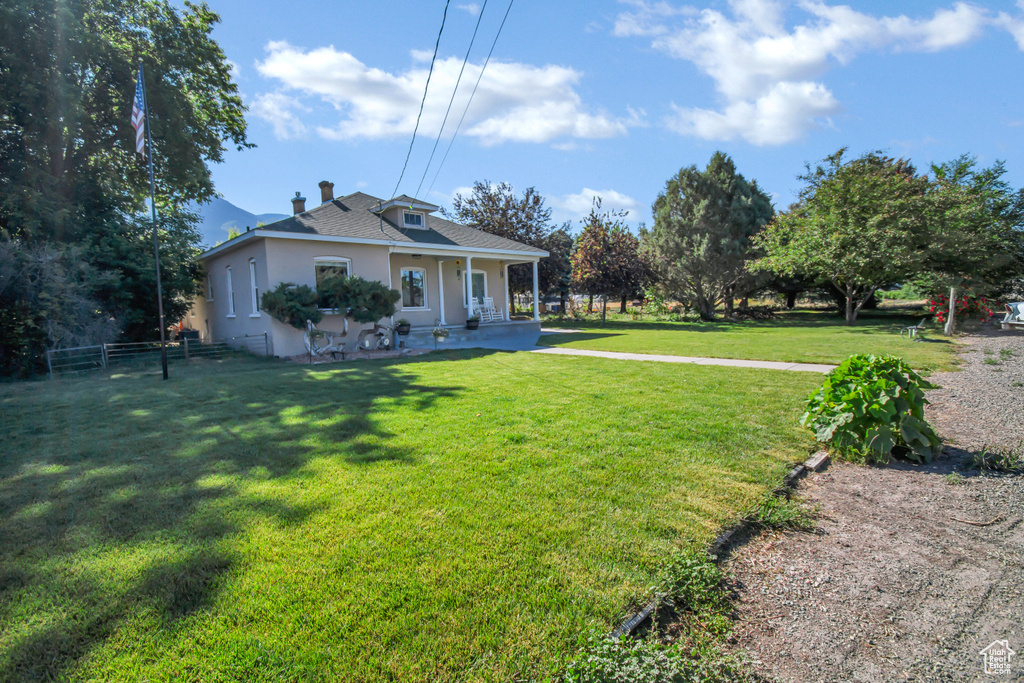 View of yard featuring covered porch
