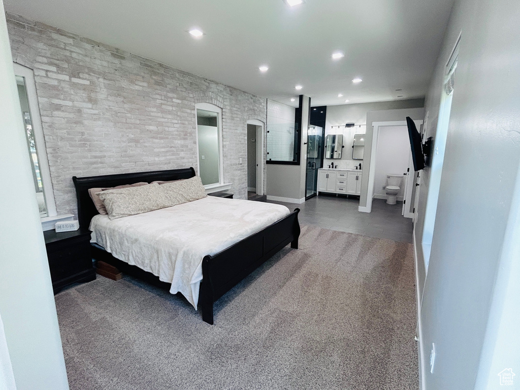Carpeted bedroom with recessed lighting and ensuite bath