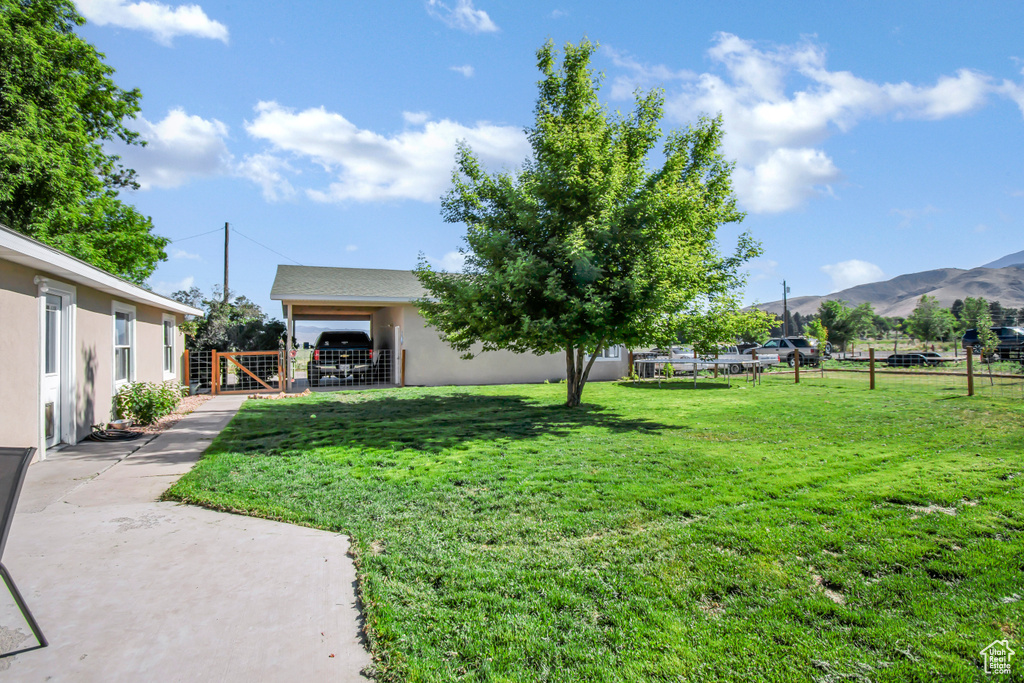 View of yard featuring a mountain view and a gate