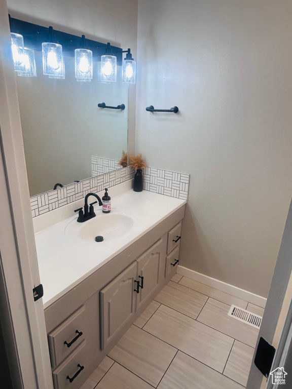 Bathroom featuring vanity and baseboards