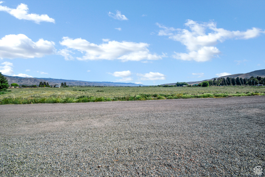 View of dirt / gravel road featuring a mountain view and a rural view