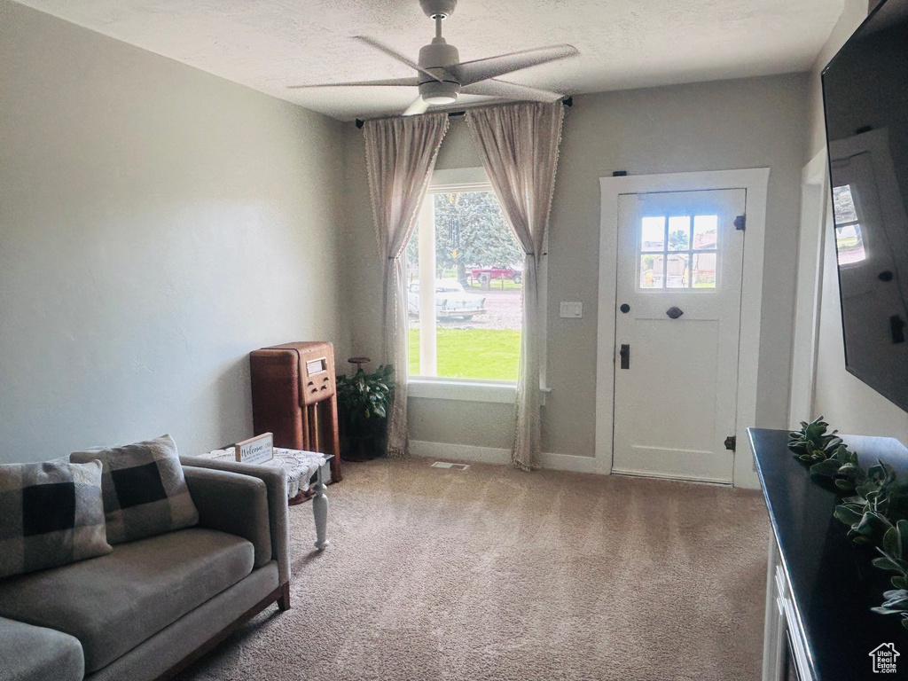 Sitting room featuring carpet floors and a ceiling fan