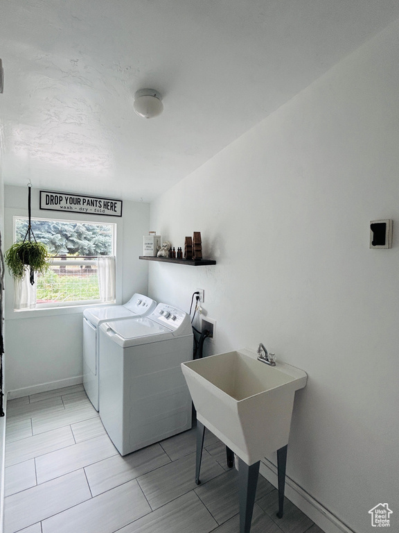 Laundry area featuring washing machine and clothes dryer and baseboards