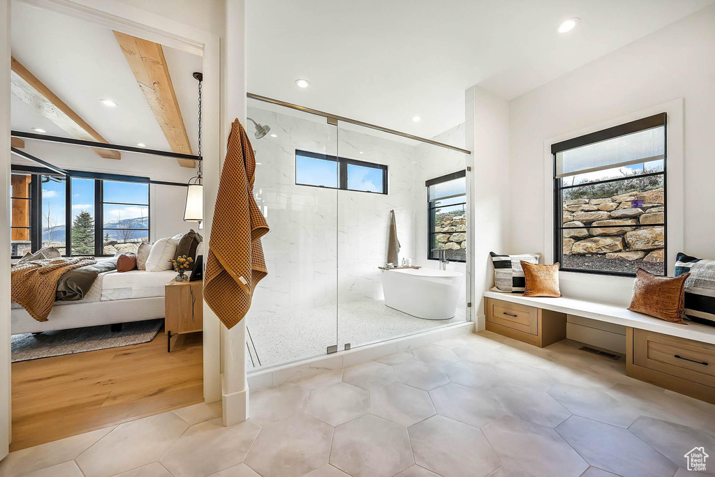 Ensuite bathroom featuring a soaking tub, recessed lighting, a marble finish shower, and tile patterned flooring