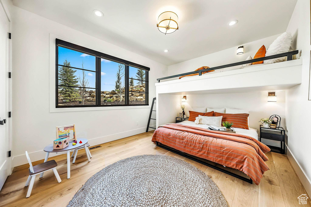 Bedroom with light wood-type flooring and recessed lighting