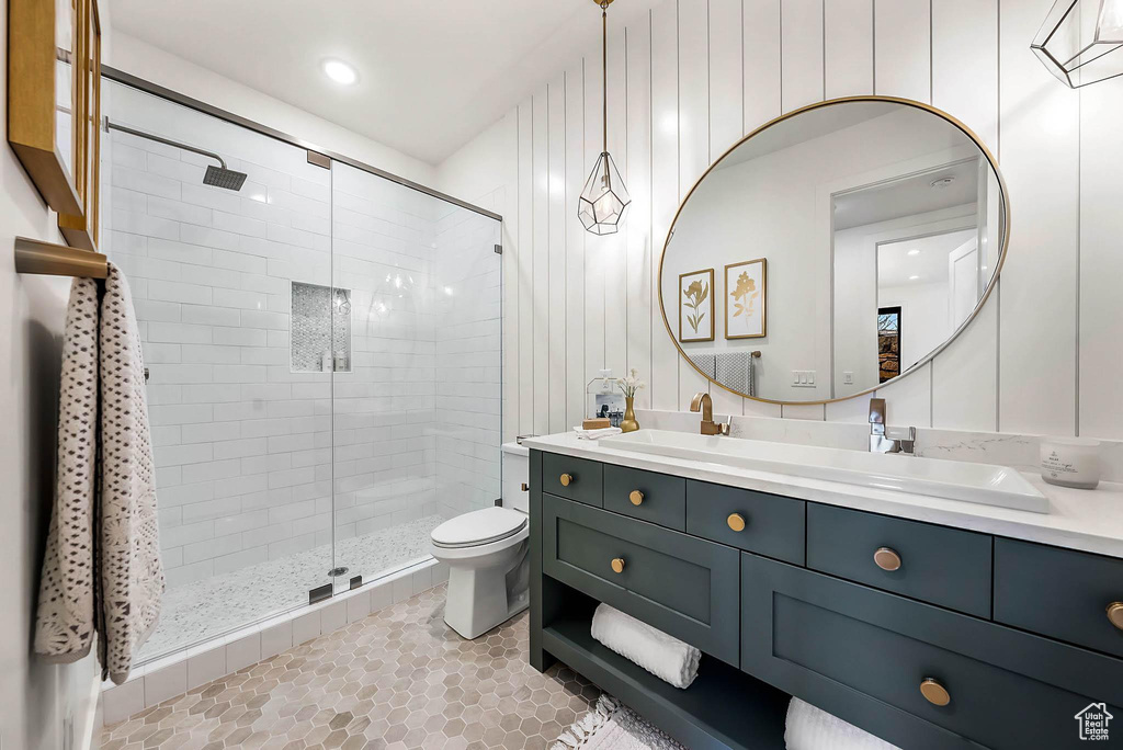 Full bathroom featuring a shower stall, vanity, and tile patterned floors