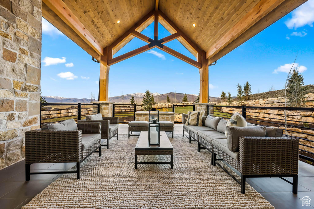 View of patio featuring an outdoor hangout area, a mountain view, and a gazebo