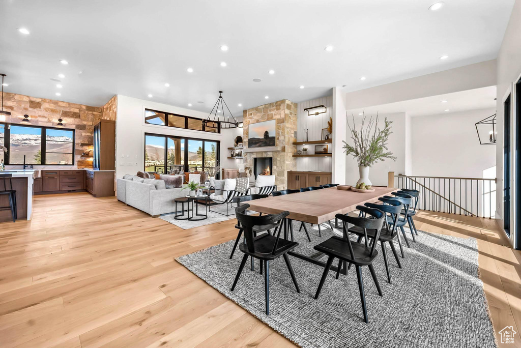 Dining space featuring recessed lighting, light wood finished floors, and a towering ceiling