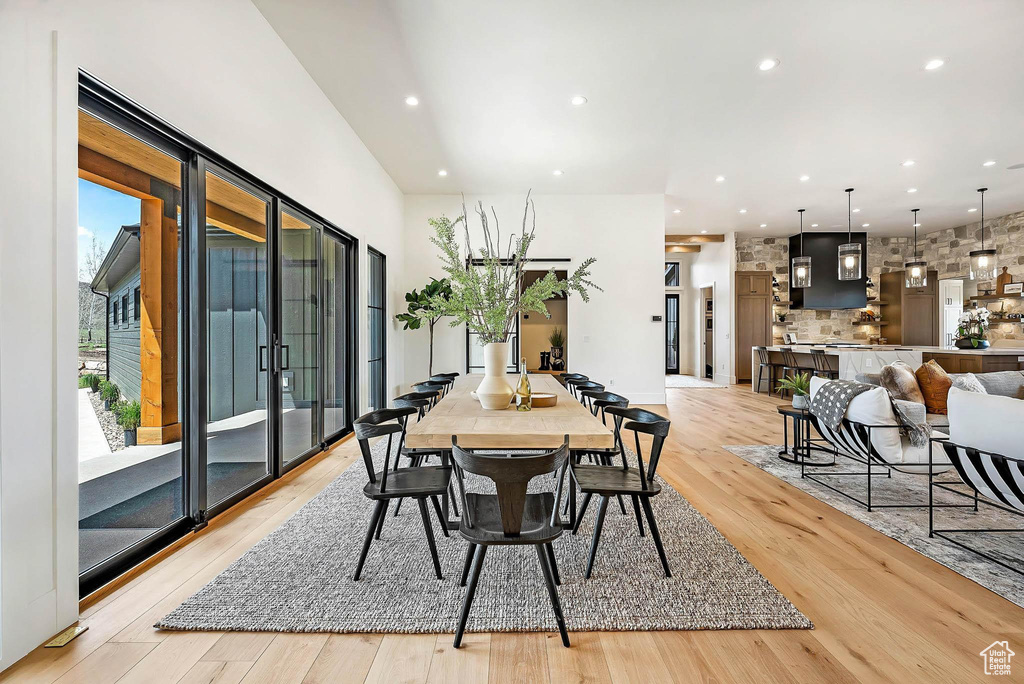 Dining space with light wood-type flooring and recessed lighting