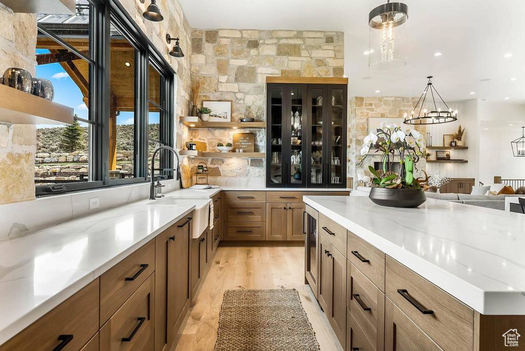 Bar area featuring decorative light fixtures, beverage cooler, and a chandelier