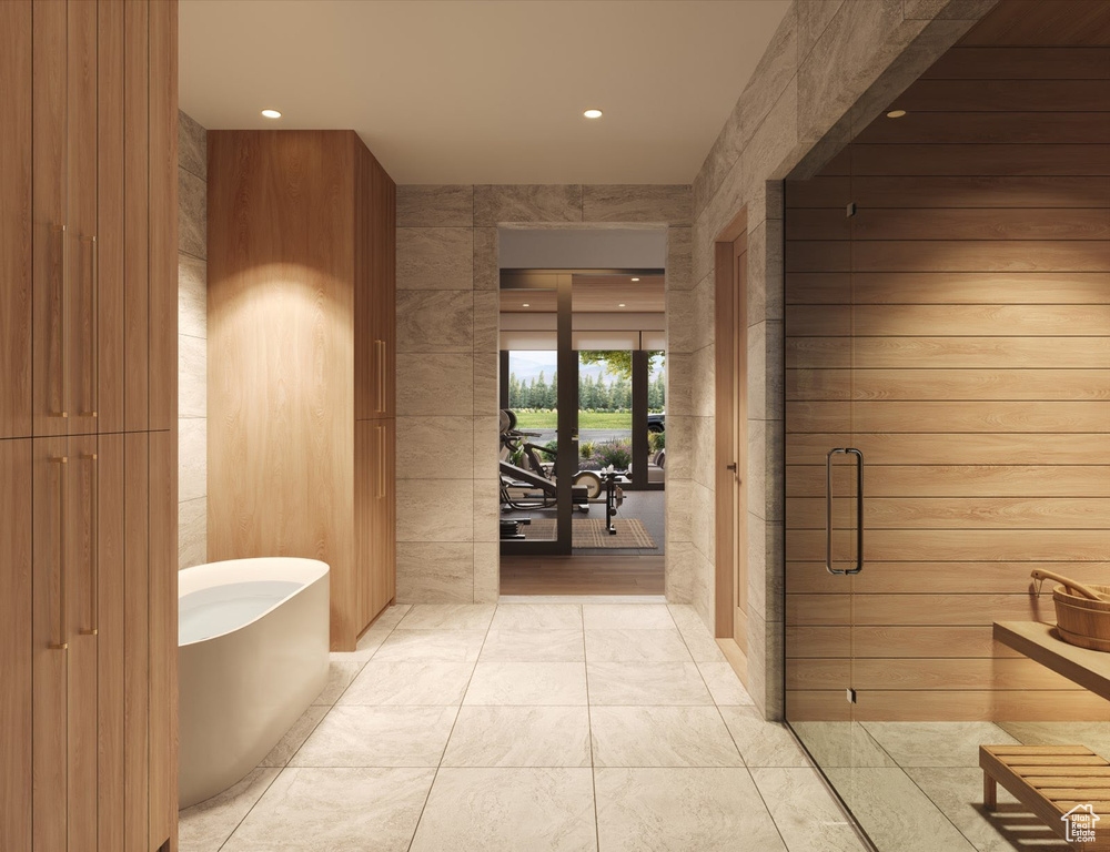 Full bath with a freestanding tub, recessed lighting, and a shower stall