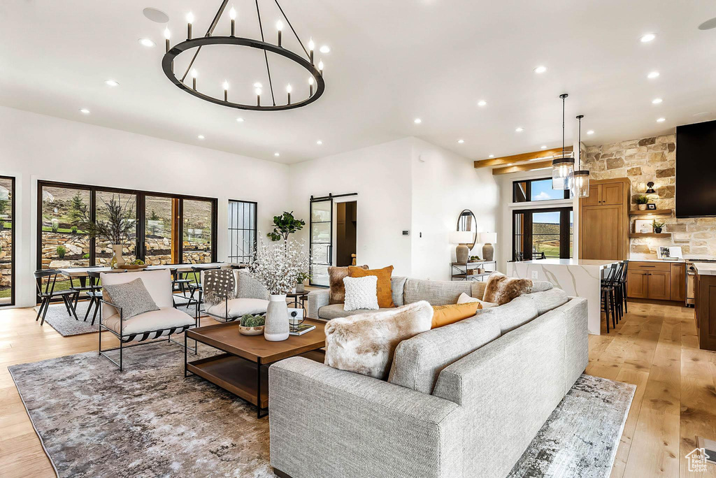 Living area featuring recessed lighting, a chandelier, light wood-type flooring, and a barn door