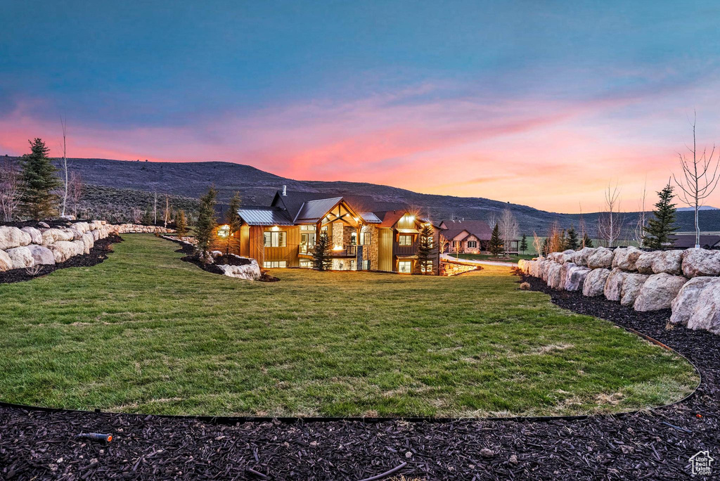 View of grassy yard with a mountain view