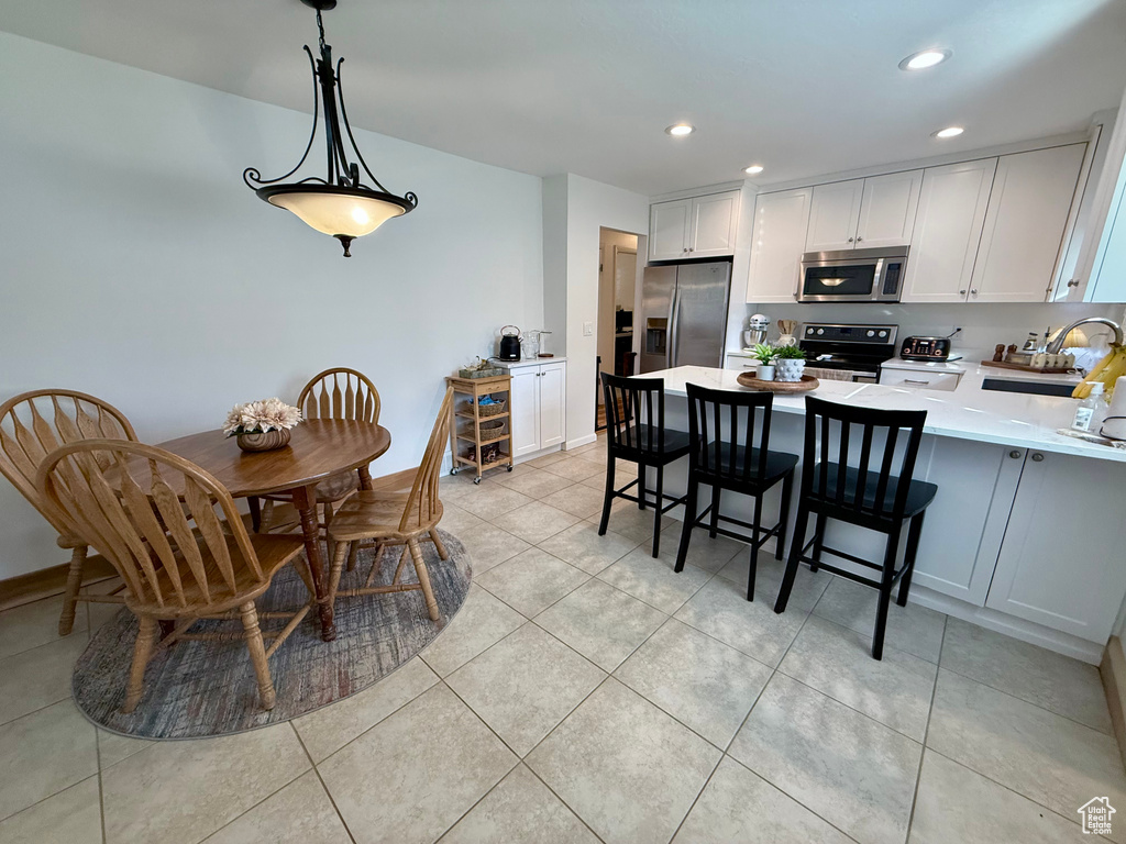 Dining room featuring light tile patterned floors and recessed lighting