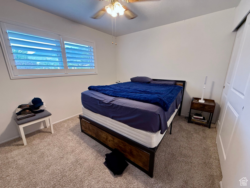 Bedroom with carpet floors and a ceiling fan
