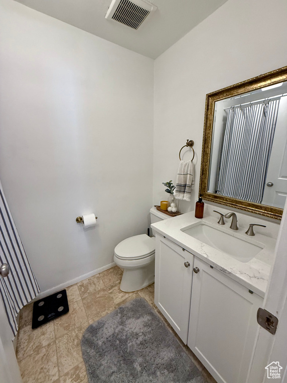 Half bath with vanity and toilet