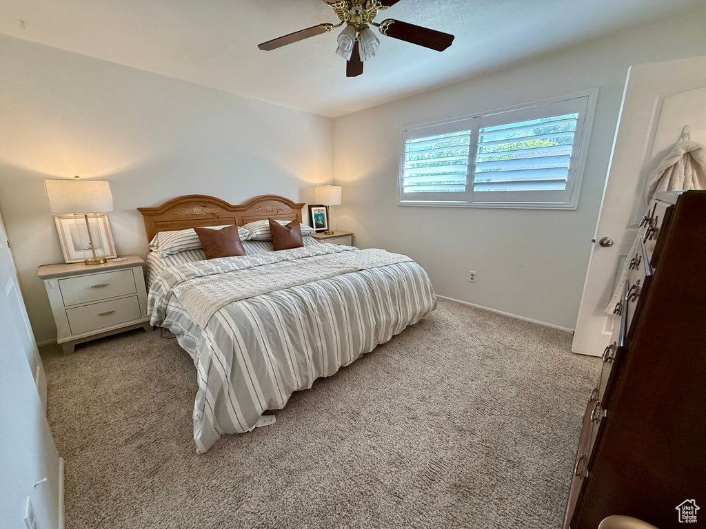 Bedroom featuring light carpet and a ceiling fan
