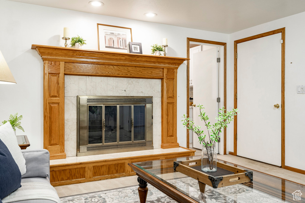 Living area with a tile fireplace and recessed lighting