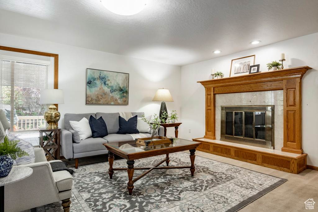 Living area featuring light carpet, a fireplace, and recessed lighting