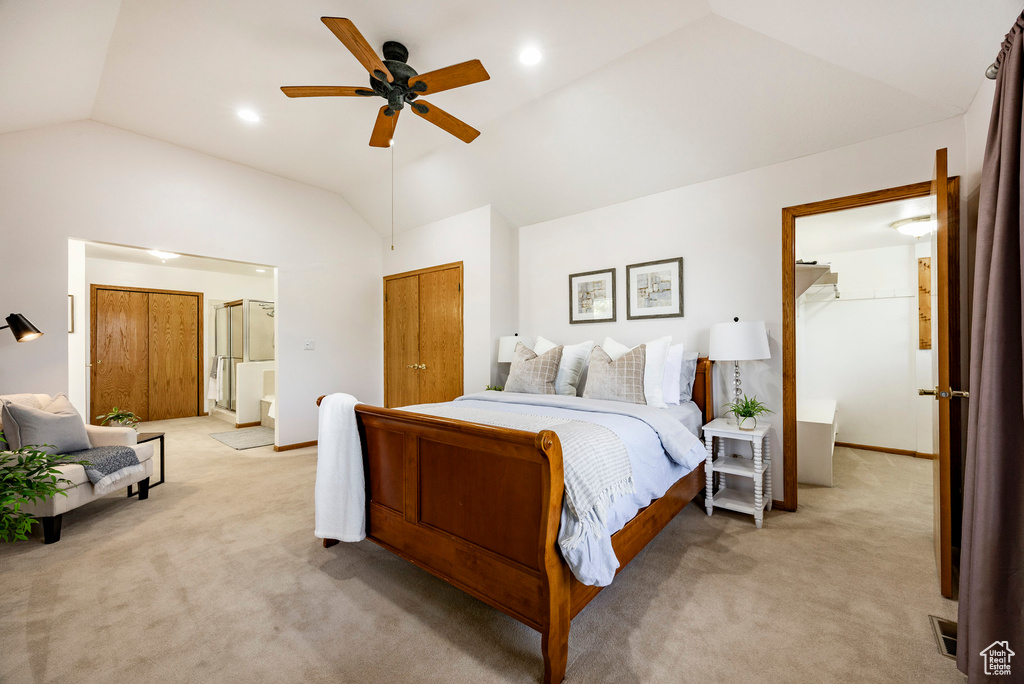 Bedroom with vaulted ceiling, light colored carpet, and ceiling fan