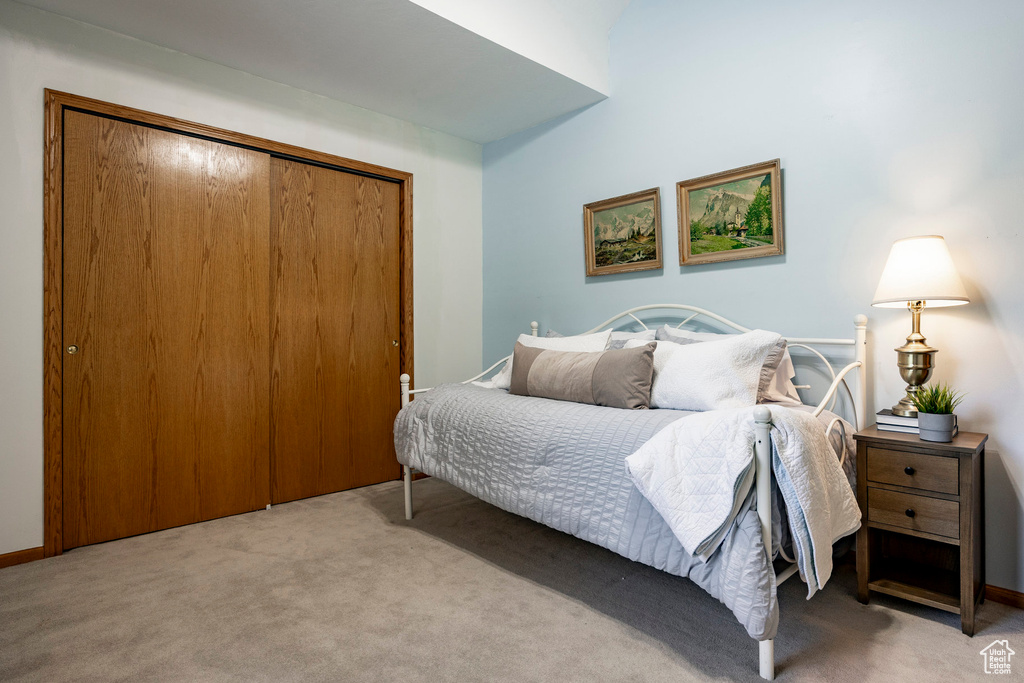Bedroom featuring carpet and a closet