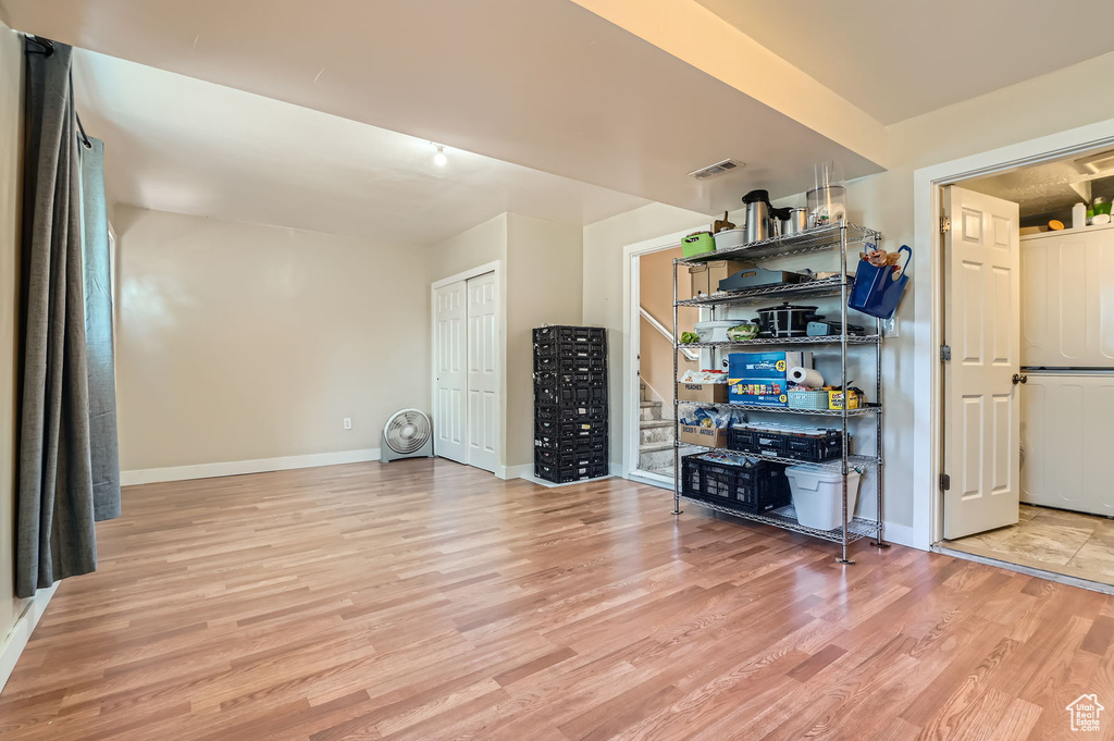 Living area with wood finished floors and baseboards