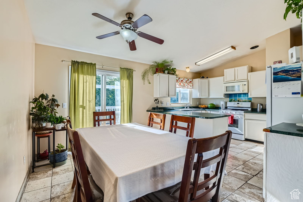 Dining area featuring ceiling fan and lofted ceiling