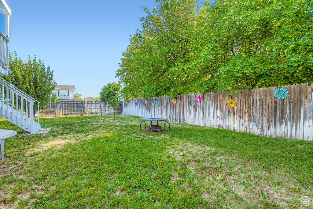 Fenced backyard with stairway