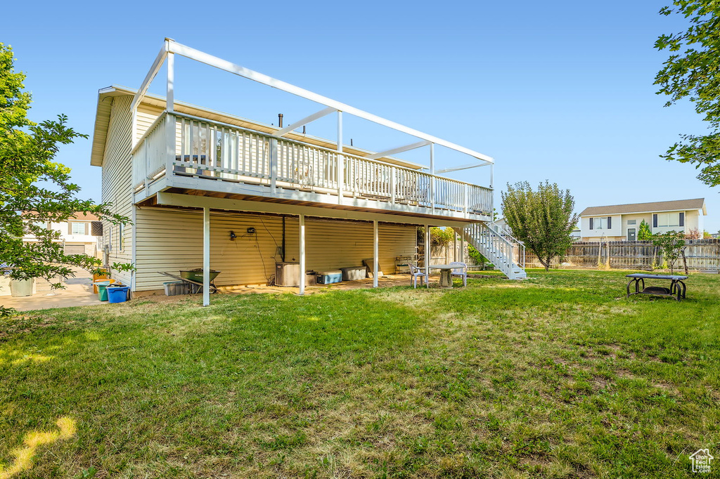Rear view of property with stairway and a deck