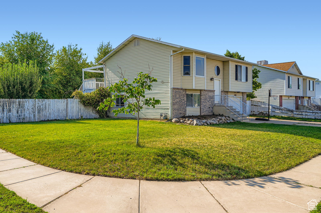 View of front of property with an attached garage, concrete driveway, and brick siding