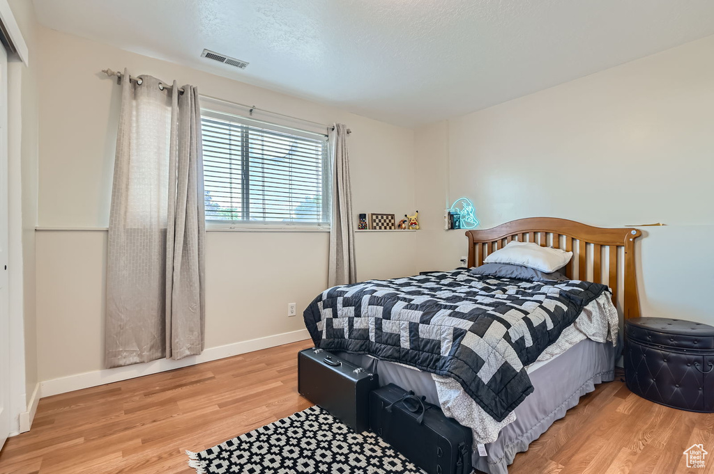 Bedroom featuring light wood-type flooring and baseboards