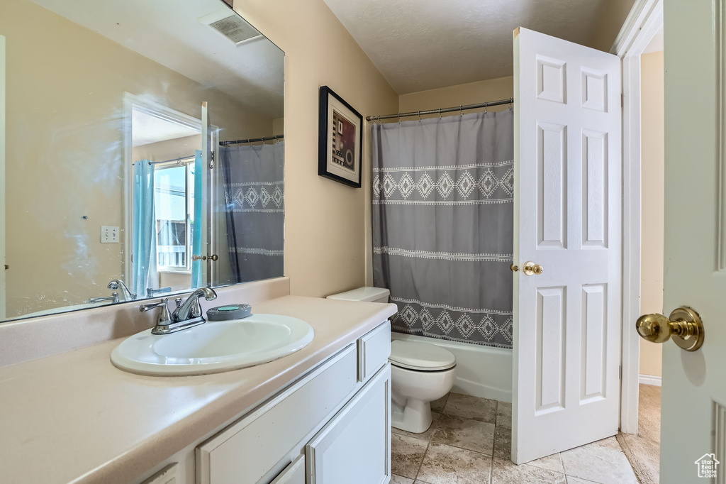 Full bath featuring vanity and shower / bath combo with shower curtain