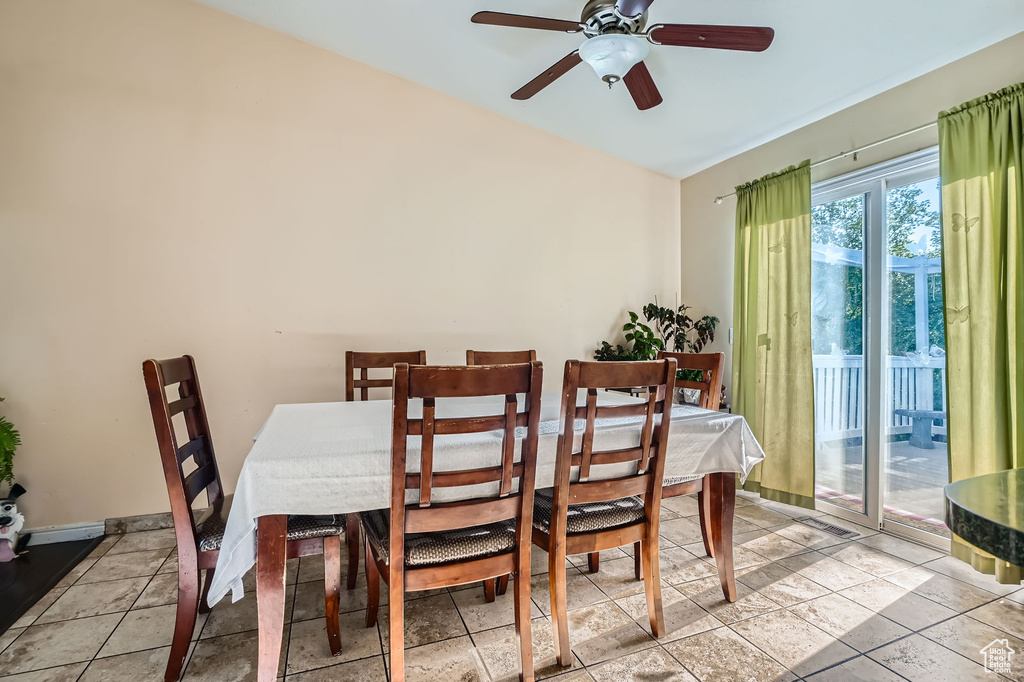 Dining room featuring a ceiling fan and lofted ceiling